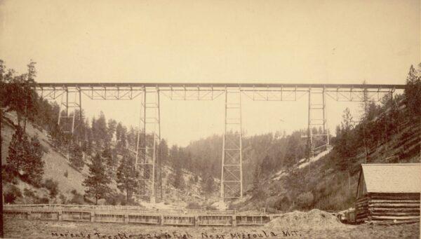 Railroad tracks run across the Marent Trestle in Missoula County, Mont., circa 1883. (Public Domain)