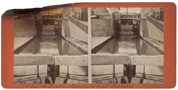 A boat passes through one of the Erie Canal’s many locks. (Public Domain)