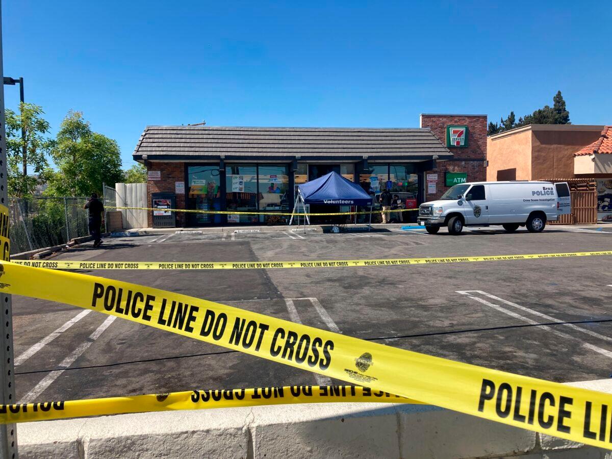 Police crime scene tape closes off a parking area following a shooting at a 7-Eleven store in Brea, Calif., on July 11, 2022. (Eugene Garcia/AP Photo)
