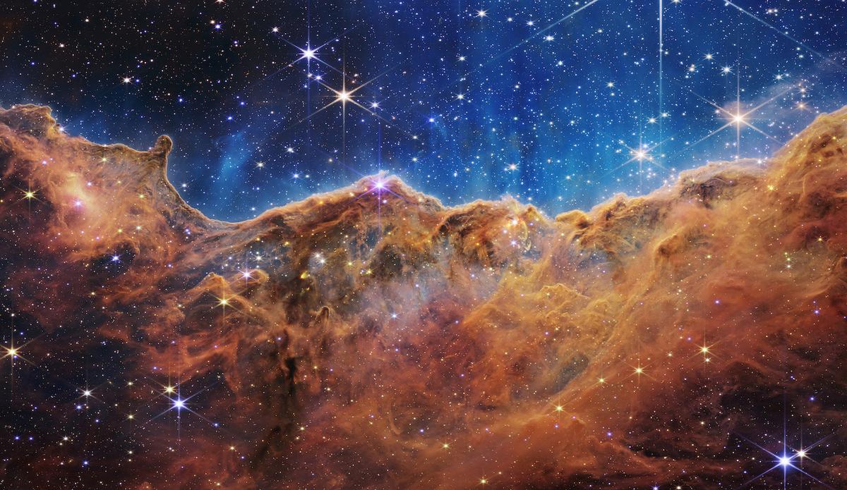 “Cosmic Cliffs” in the Carina Nebula. (<a href="https://webbtelescope.org/contents/media/images/2022/031/01G77PKB8NKR7S8Z6HBXMYATGJ?news=true">NASA, ESA, CSA, STScI</a>)