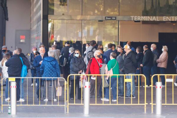 Passengers from the Coral Princess wait to board buses on July 13, 2022 in Sydney, Australia. (Jenny Evans/Getty Images)