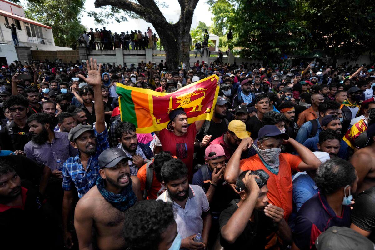 Sri Lankan protesters storm the compound of Prime Minister Ranil Wickremesinghe's office, demanding he resign after President Gotabaya Rajapaksa fled the country amid an economic crisis in Colombo, Sri Lanka, on July 13, 2022. (Eranga Jayawardena/AP Photo)