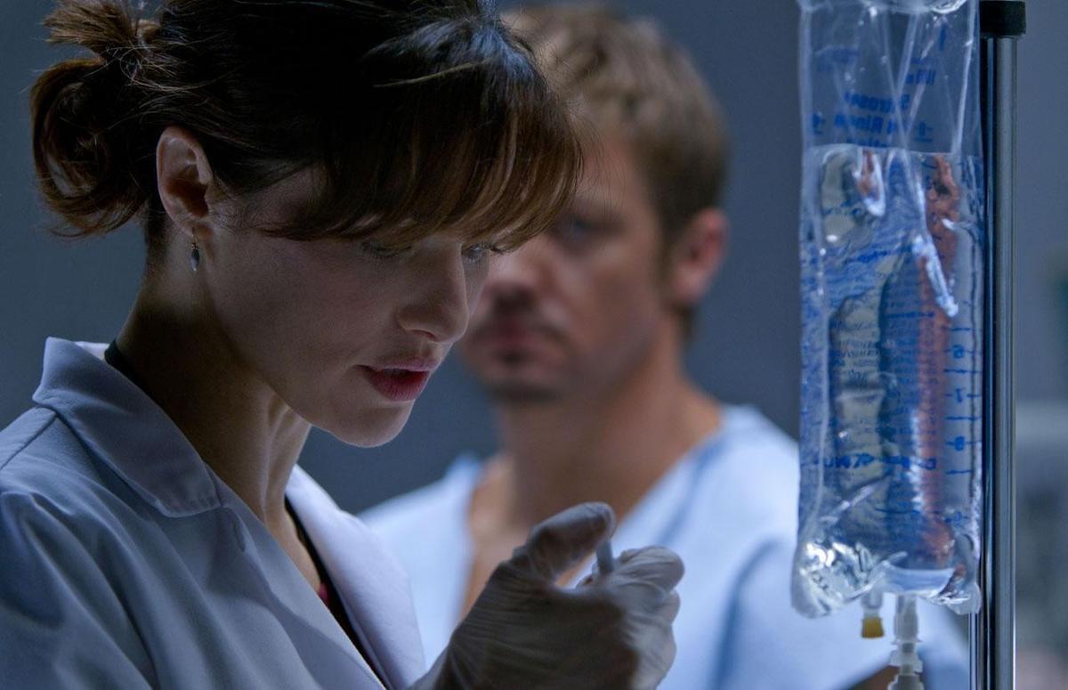 Dr. Marta Shearing (Rachel Weisz) doing a workup of Outcome agent #5 (Jeremy Renner), in "The Bourne Legacy." (Universal Pictures)