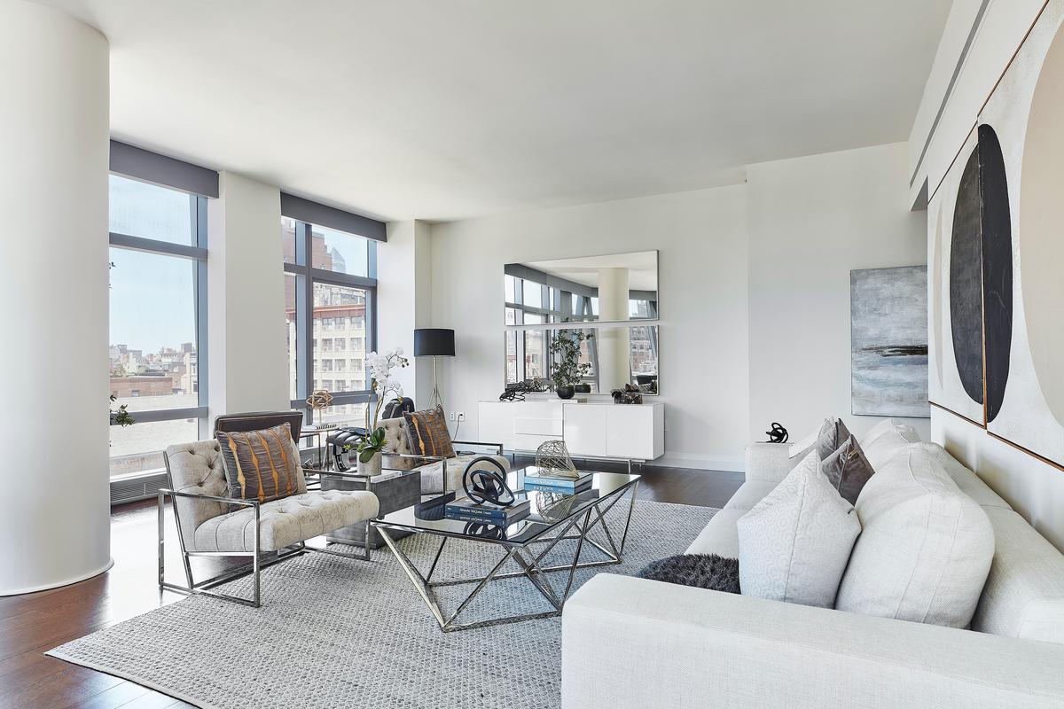 A pairing of white on white upholstery helps to make a modern living room feel more spacious. (Scott Gabriel Morris/TNS)