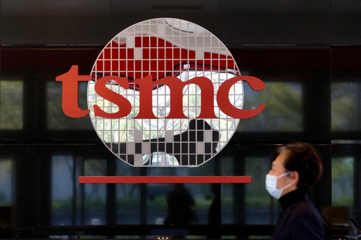 A man walks past a company logo at the headquarters of the world's largest semiconductor maker TSMC in Hsinchu, Taiwan, on Jan. 29, 2021. (Sam Yeh/AFP via Getty Images)