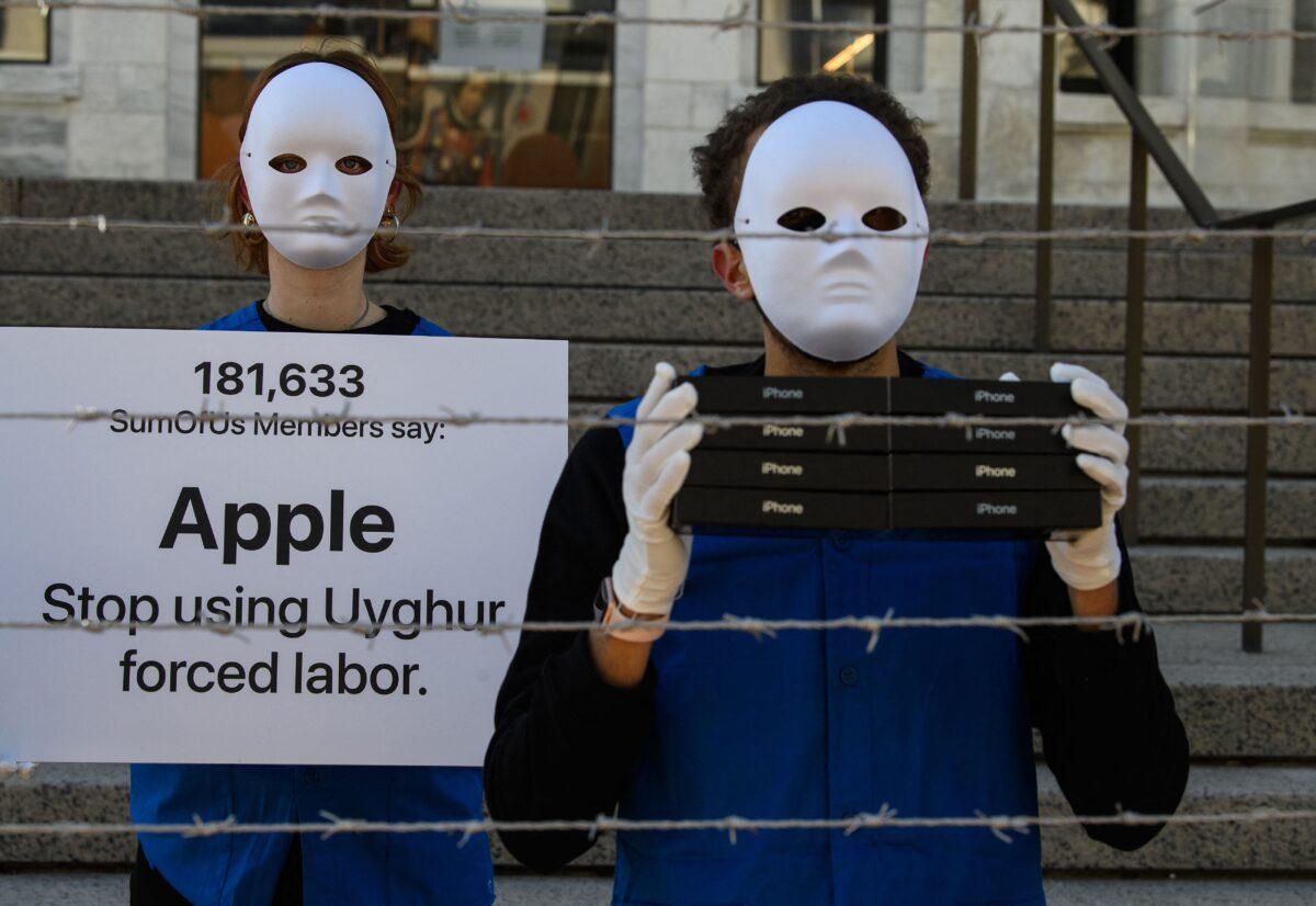 Activists set up a mock Uyghur forced labor camp outside the Apple flagship store in Washington on March 4, 2022, to call on Apple to stop using Uyghur forced labor. (Nicholas Kamm/AFP/Getty Images)