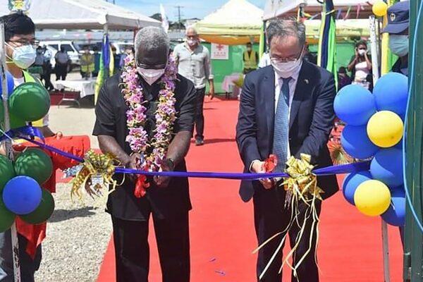 China's ambassador to the Solomon Islands Li Ming (R), and Solomons Prime Minister Manasseh Sogavare are cutting a ribbon during the opening ceremony of a China-funded national stadium complex in Honiara on April 22, 2022. (Mavis Podokolo/AFP via Getty Images)