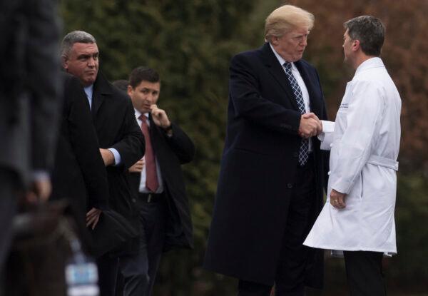 Former President Donald Trump shakes hands with then-White House Physician Rear Admiral Dr. Ronny Jackson, following his annual physical at Walter Reed National Military Medical Center in Bethesda, Maryland on Jan. 12, 2018. (Saul Loeb/AFP via Getty Images)