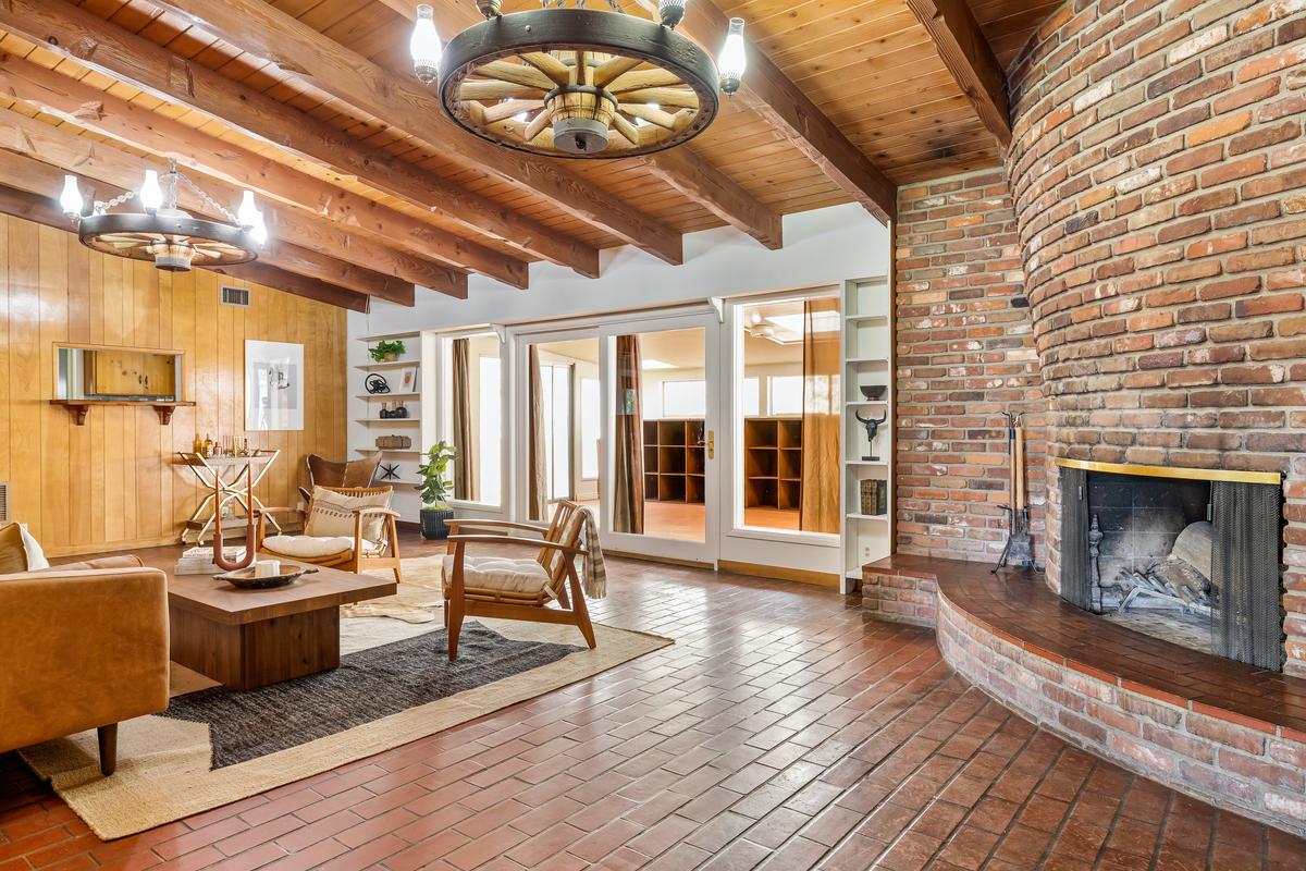 Warm wood accents, brick, and a simple elegance set this home apart. Even if the home had not once belonged to a legend, it would still be a remarkable property. (Courtesy of Mark Corcoran for Douglas Elliman Realty)