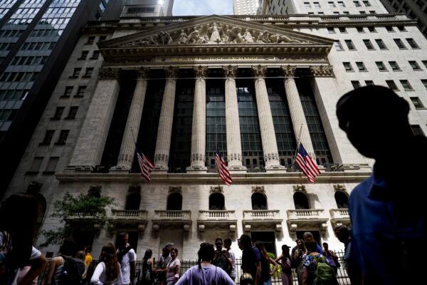 Pedestrians walk past the New York Stock Exchange on July 8, 2022. (John Minchillo/AP Photo)