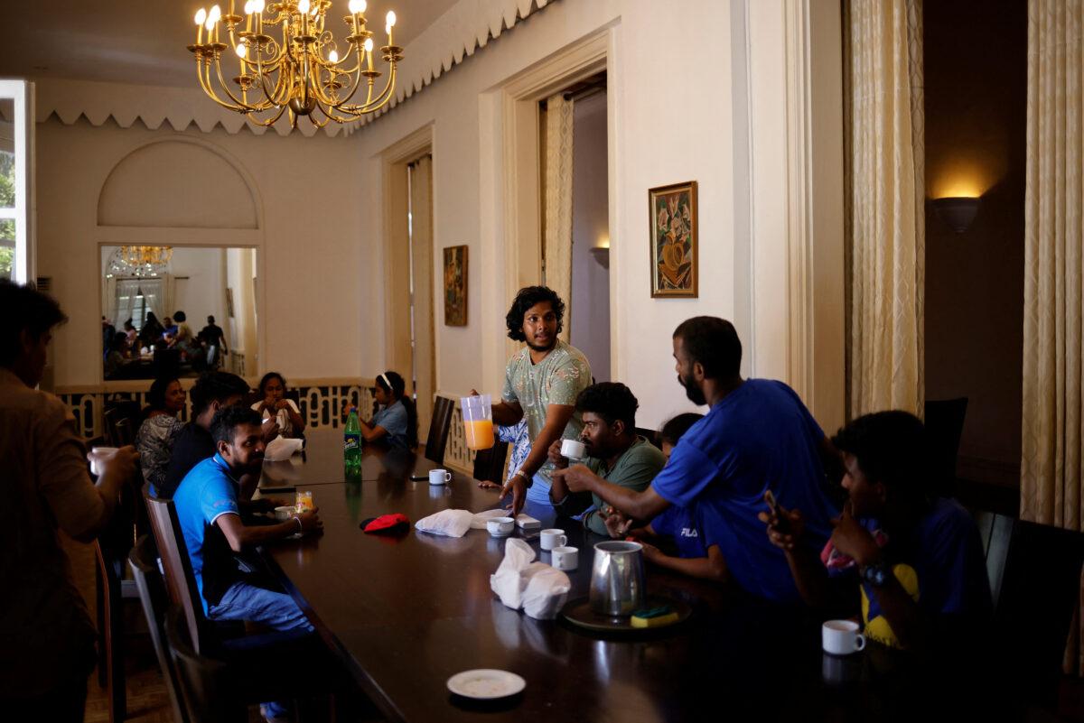 People eat breakfast inside a conference hall at the president's house after President Gotabaya Rajapaksa fled, amid the country's economic crisis, in Colombo, Sri Lanka, on July 14, 2022. (Adnan Abidi/Reuters)