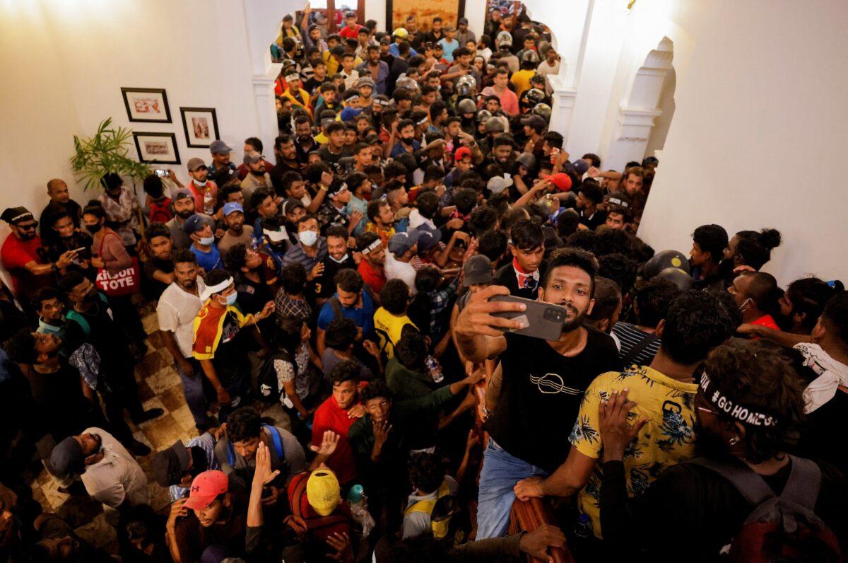 Protesters wait to enter into Sri Lankan Prime Minister Ranil Wickremesinghe's office during a protest demanding for his resignation, after President Gotabaya Rajapaksa fled, amid the country's economic crisis, in Colombo, Sri Lanka, on July 13, 2022. (Dinuka Liyanawatte/Reuters)