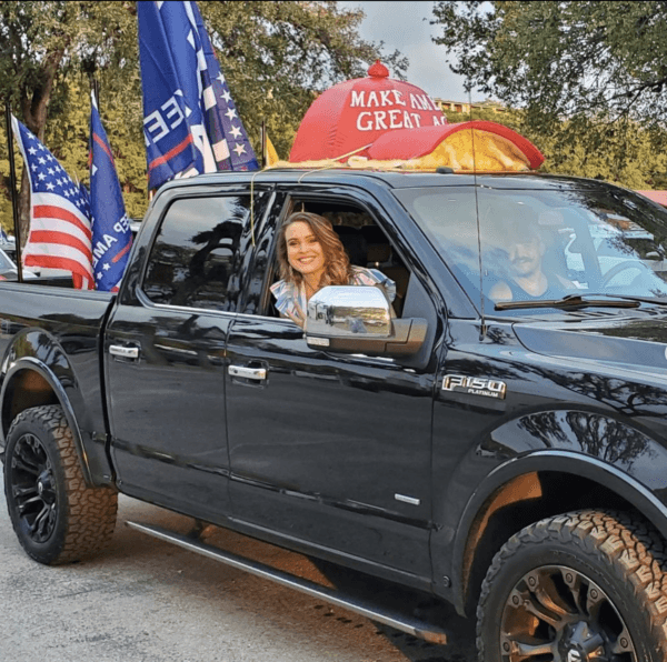 Joeylynn Mesaros sits in a truck with flags and a giant "Make America Great Again" hat.  (Courtesy of Joeylynn Mesaros)