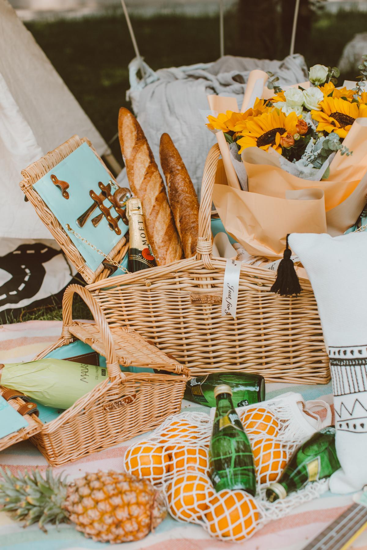 A picnic can be as complex as you want, or as simple as a loaf of French bread and wine (and water for the kids!). (Kin Li/Unsplash)