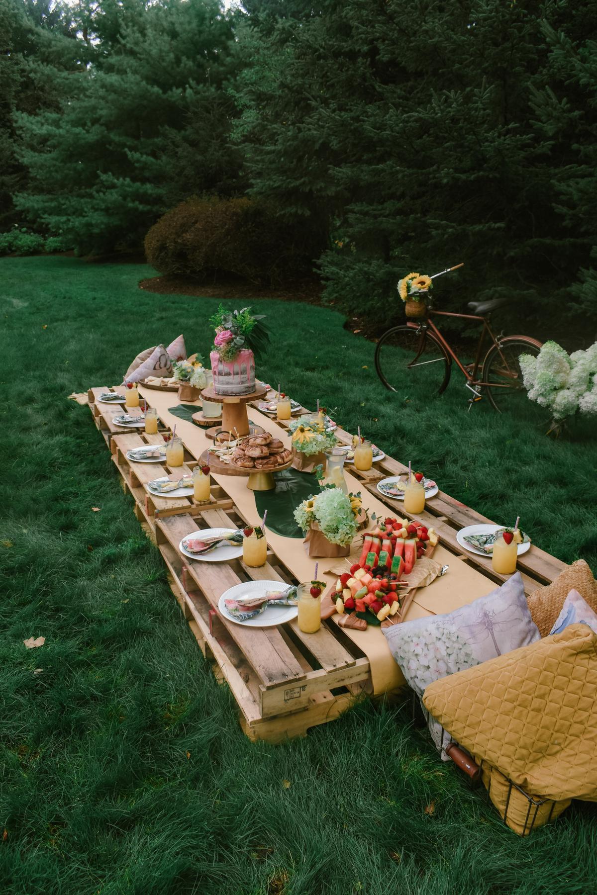 Use an assortment of foods to “decorate” the picnic table, making your al fresco meal memorable and fun.<br/>(Mariah Hewines/Unsplash)