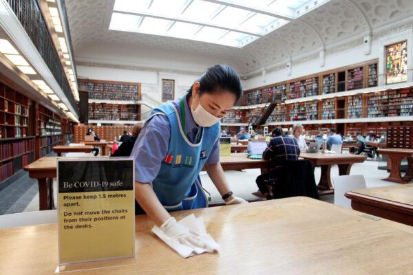 A member of the cleaning staff wipes down a table in the State Library of New South Wales in Sydney, Australia, on June 1, 2020. (Lisa Maree Williams/Getty Images)