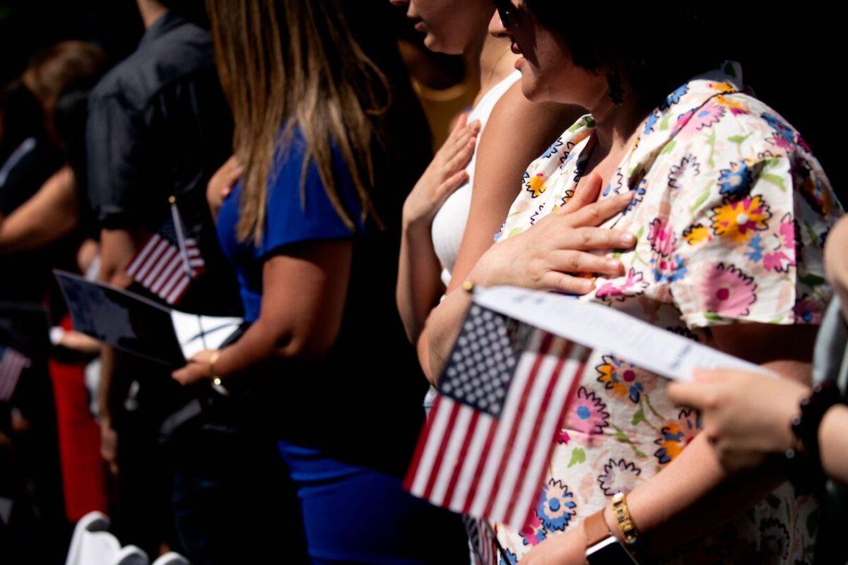New US citizens recite the Pledge of Allegiance during their naturalization ceremony at George Washingtons residence in Mount Vernon, Virginia, on July 4, 2022. (Stefani Reynolds/AFP via Getty Images)