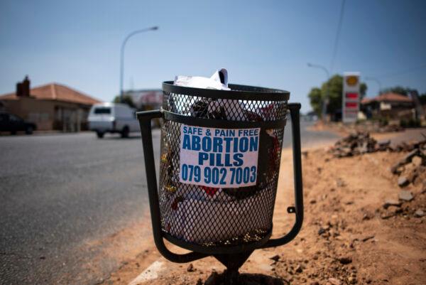 File photo: A poster advertising illegal abortion pills is seen on a bin in Sophiatown, Johannesburg, on September 29, 2020. (Luca Sola/AFP via Getty Images)