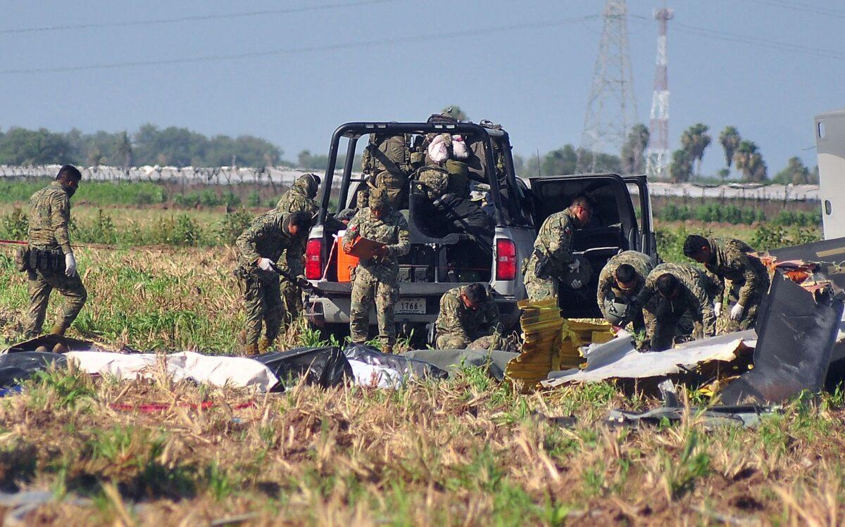 Soldiers of the Mexican Army work at the site of a Navy helicopter crash near the airport of Los Mochis, Sinaloa State, Mexico, on July 15, 2022. (Jose Mendoza/AFP via Getty Images)