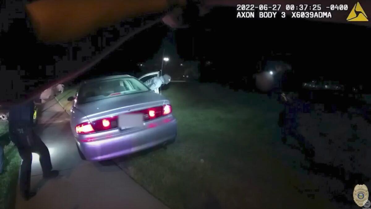 A still image taken from body camera footage shows Jayland Walker, 25, jumping out of the passenger side of his vehicle wearing a black mask as he attempts to flee a traffic stop over equipment violations. (Courtesy of Akron Police Department)