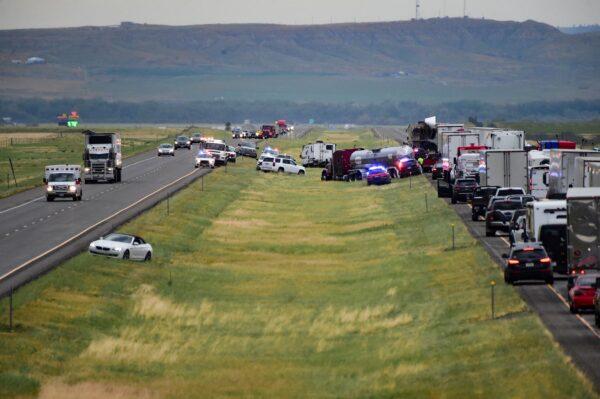 First responders work the scene on Interstate 90 after a fatal pileup where at least 20 vehicles crashed near Hardin, Mont., on July 15, 2022. (Amy Lynn Nelson/The Billings Gazette via AP)