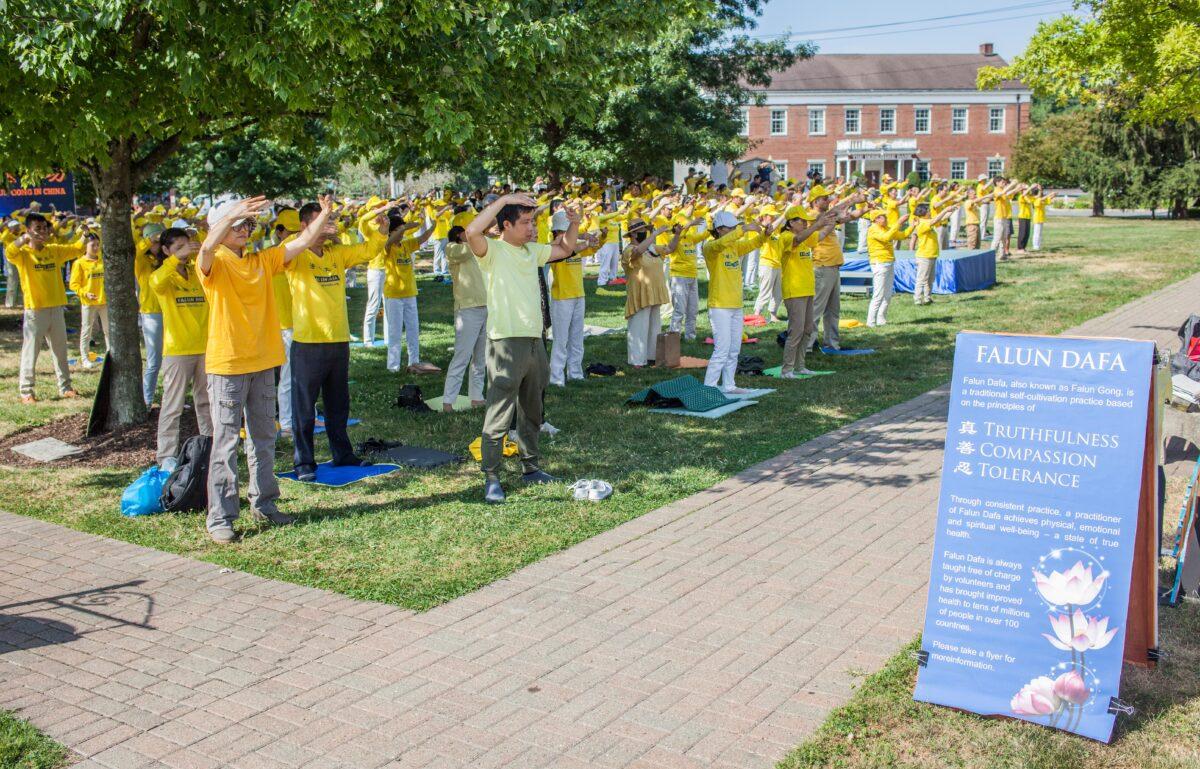 Falun Gong adherents practice meditative exercises in a park in Goshen., N.Y., on July 17, 2022. A few hundred adherents of the spiritual practice gathered in the park to commemorate the 23 years since the Chinese Communist Party launched a persecution of their fellows in faith in China. (Petr Svab/The Epoch Times)