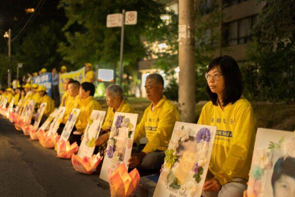  Falun Gong practitioners hold a candlelight vigil outside the Chinese consulate in Toronto on July 16, 2022, marking the 23 year of the persecution launched by the Chinese Communist regime against their fellow adherents in China. (Evan Ning/The Epoch Times)
