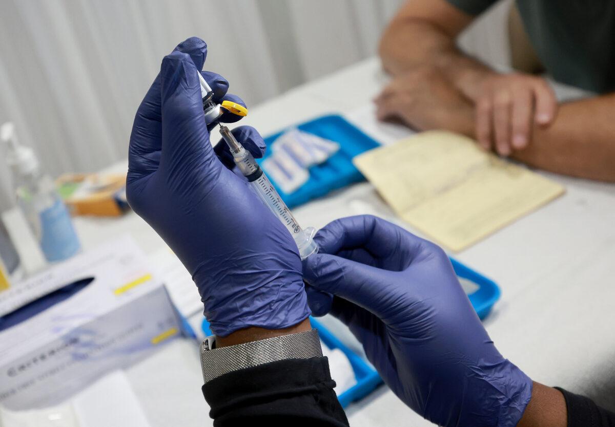 A health care worker prepares to administer a monkeypox vaccine at the Pride Center in Wilton Manors, Fla., on July 12, 2022. (Joe Raedle/Getty Images)