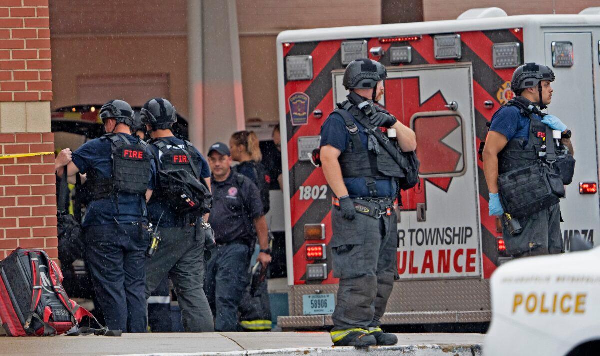 Law enforcement wait outside after a deadly shooting at the Greenwood Park Mall in Greenwood, Ind., on July 17, 2022. (Kelly Wilkinson/The Indianapolis Star via AP)