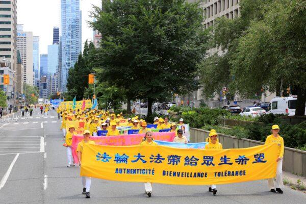  Falun Gong adherents participate in a parade in downtown Toronto on July 17, 2022, calling for an end to the persecution of their fellow adherents in China. (Evan Ning/The Epoch Times)