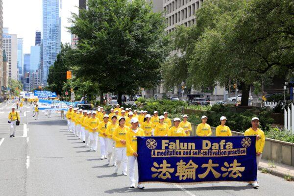 Falun Gong adherents participate in a parade in downtown Toronto on July 17, 2022, calling for an end to the persecution of their fellow adherents in China. (Evan Ning/The Epoch Times)