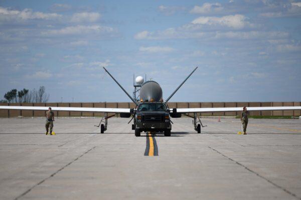 Airmen assigned to the 319th Aircraft Maintenance Squadron from Grand Forks Air Force Base, North Dakota, tow an RQ-4 Block 30 Global Hawk remotely piloted aircraft on June 6, 2022. (U.S. Air Force photo by Senior Airman Ashley Richards)