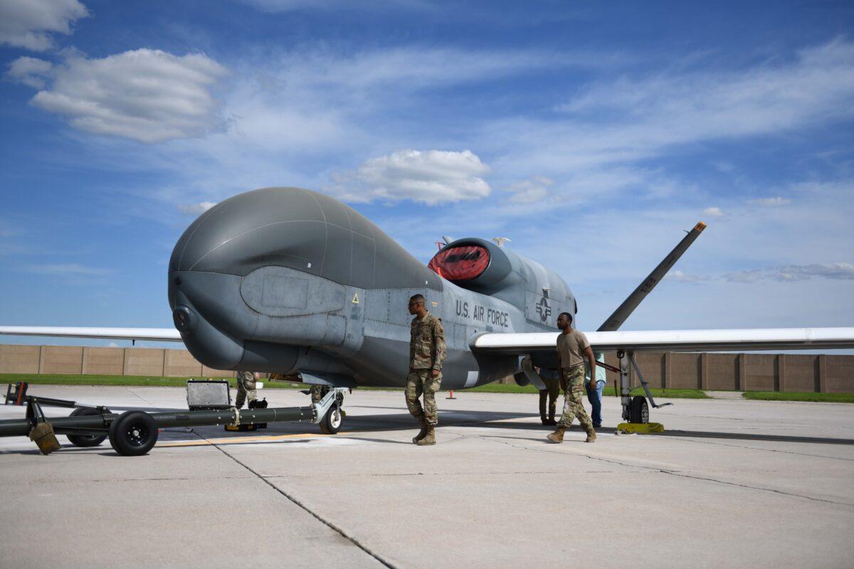 Airmen assigned to the 319th Aircraft Maintenance Squadron from Grand Forks Air Force Base, North Dakota, perform a maintenance check on a drone on June 6, 2022. (U.S. Air Force photo by Senior Airman Ashley Richards)