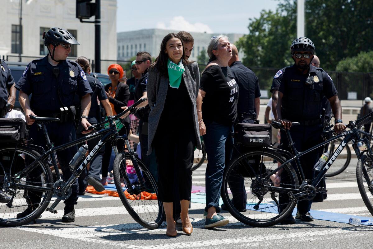 Rep. Alexandria Ocasio-Cortez (D-N.Y.) is detained after participating in a sit in with activists from Center for Popular Democracy Action in front of the U.S. Supreme Court Building in Washington on July 19, 2022. (Anna Moneymaker/Getty Images)