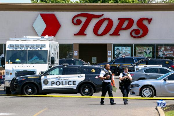 Police walk outside the Tops grocery store, in Buffalo, N.Y., on May 15, 2022. (Joshua Bessex/AP Photo)