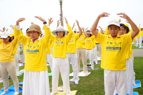 Falun Dafa practitioners demonstrate five exercises at a rally to raise awareness of the Chinese Communist Party's persecution of Falun Dafa in Santa Monica, Calif., on July 17, 2022. (Debora Cheng/The Epoch Times)