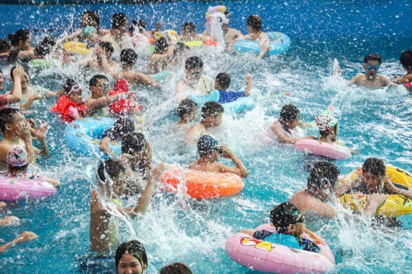 People are cooling off in a pool to escape the hot weather at a water park in Huaian, in China's eastern Jiangsu Province on July 18, 2022. (STR/AFP via Getty Images)