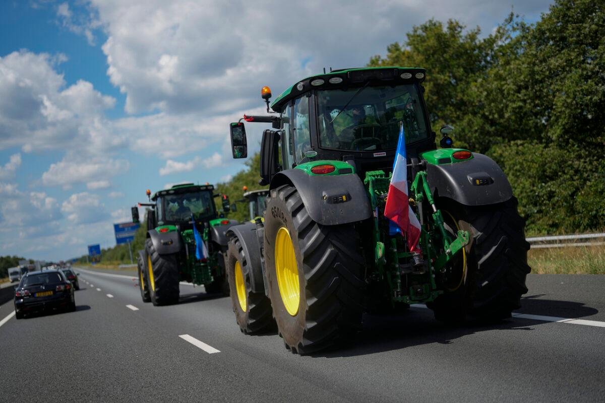 Demonstrating farmers slowing traffic on a motorway near Venlo, Netherlands, on July 4, 2022. Dutch farmers angry at government plans to slash emissions used tractors and trucks to blockade supermarket distribution centers, the latest actions in a summer of discontent in the country's lucrative agricultural sector. (Thibault Camus/AP Photo)