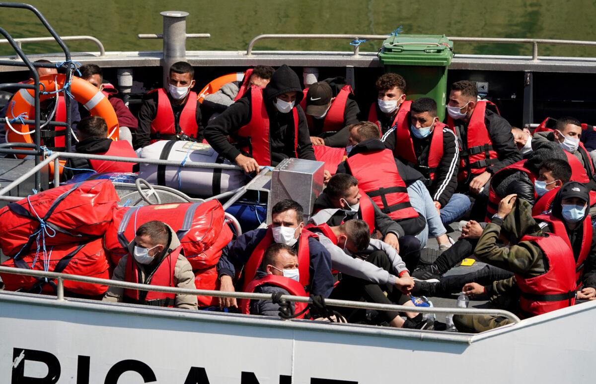 A group of people thought to be migrants are brought in to Dover, Kent, England, onboard a Border Force vessel on July 18, 2022. (Gareth Fuller/PA Media)