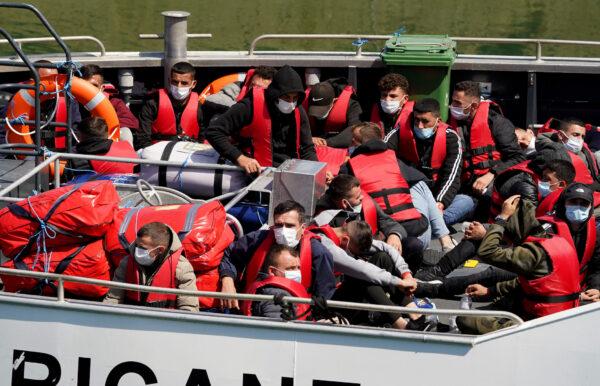 A group of people thought to be illegal immigrants are brought into Dover, Kent, England, onboard a Border Force vessel on July 18, 2022. (Gareth Fuller/PA Media)