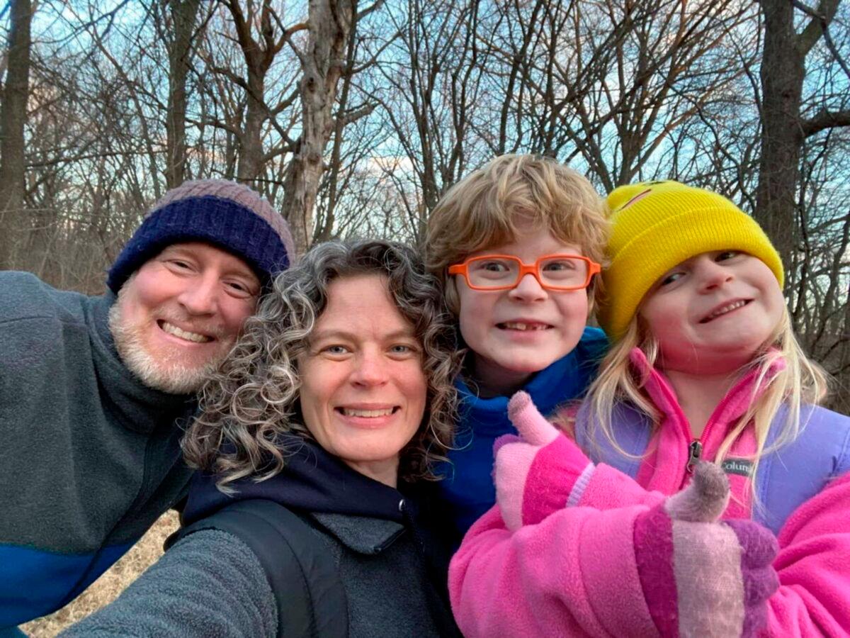 Tyler Schmidt (L) and his wife Sarah pose with their son Arlo and daughter Lula (R) while hiking near Cedar Falls, Iowa, in 2022. (Courtesy of the Schmidt and Morehead families via AP)