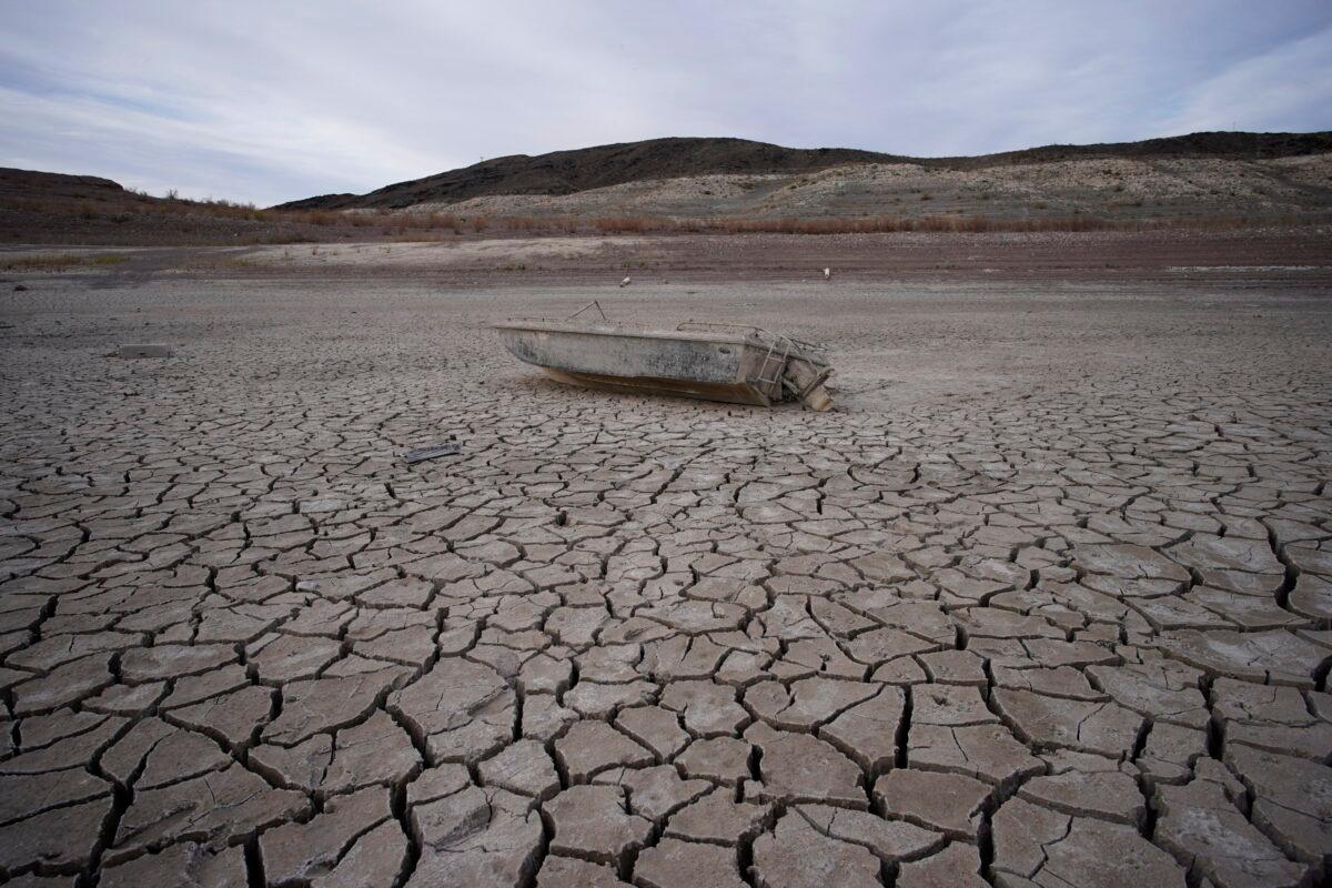A formerly sunken boat sits on cracked earth hundreds of feet from the shoreline of Lake Mead at the Lake Mead National Recreation Area on May 10, 2022. (John Locher/AP)