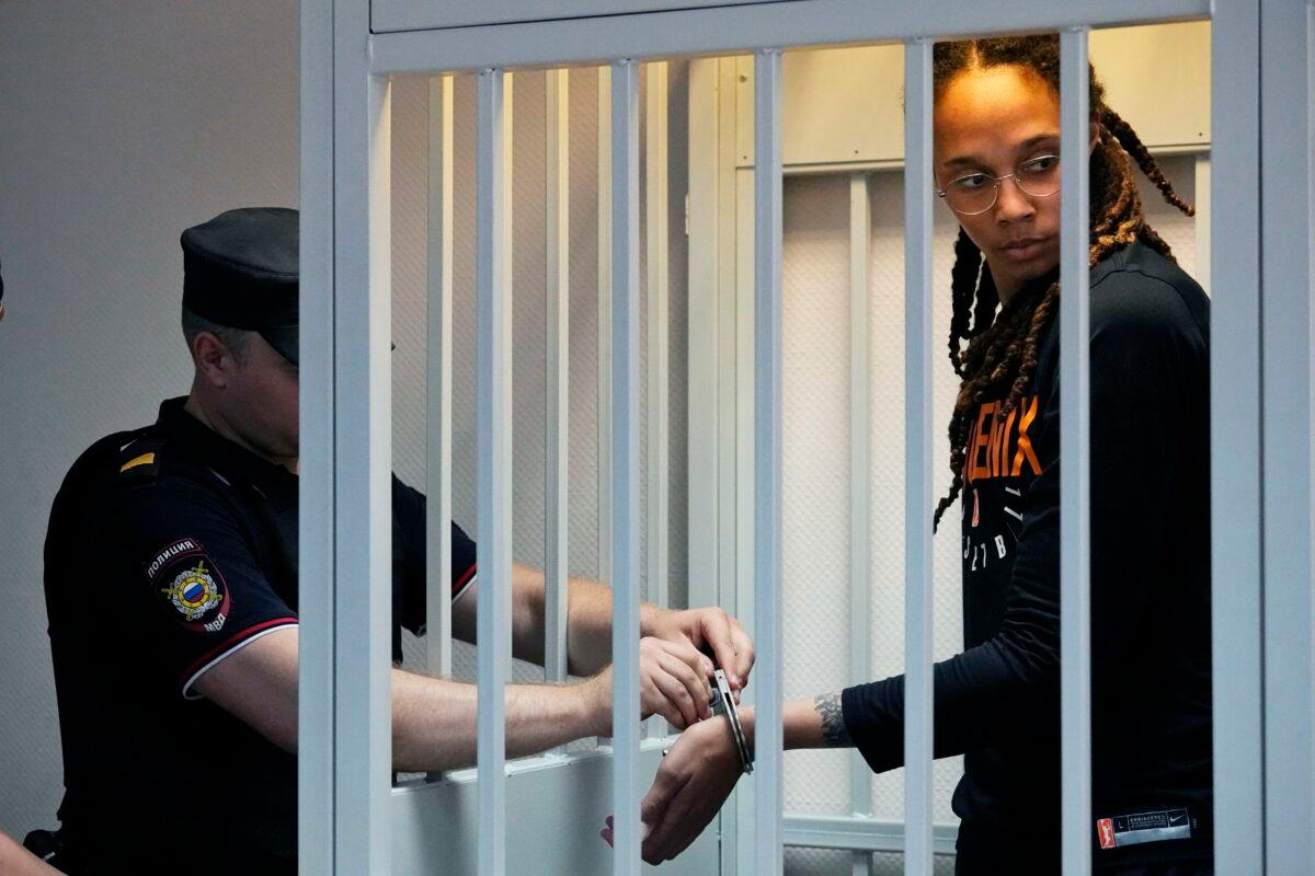 A policeman removes the handcuffs from WNBA player and two-time Olympic gold medalist Brittney Griner in a courtroom prior to a hearing in Khimki just outside Moscow on July 27, 2022. (Alexander Zemlianichenko/AP Photo)