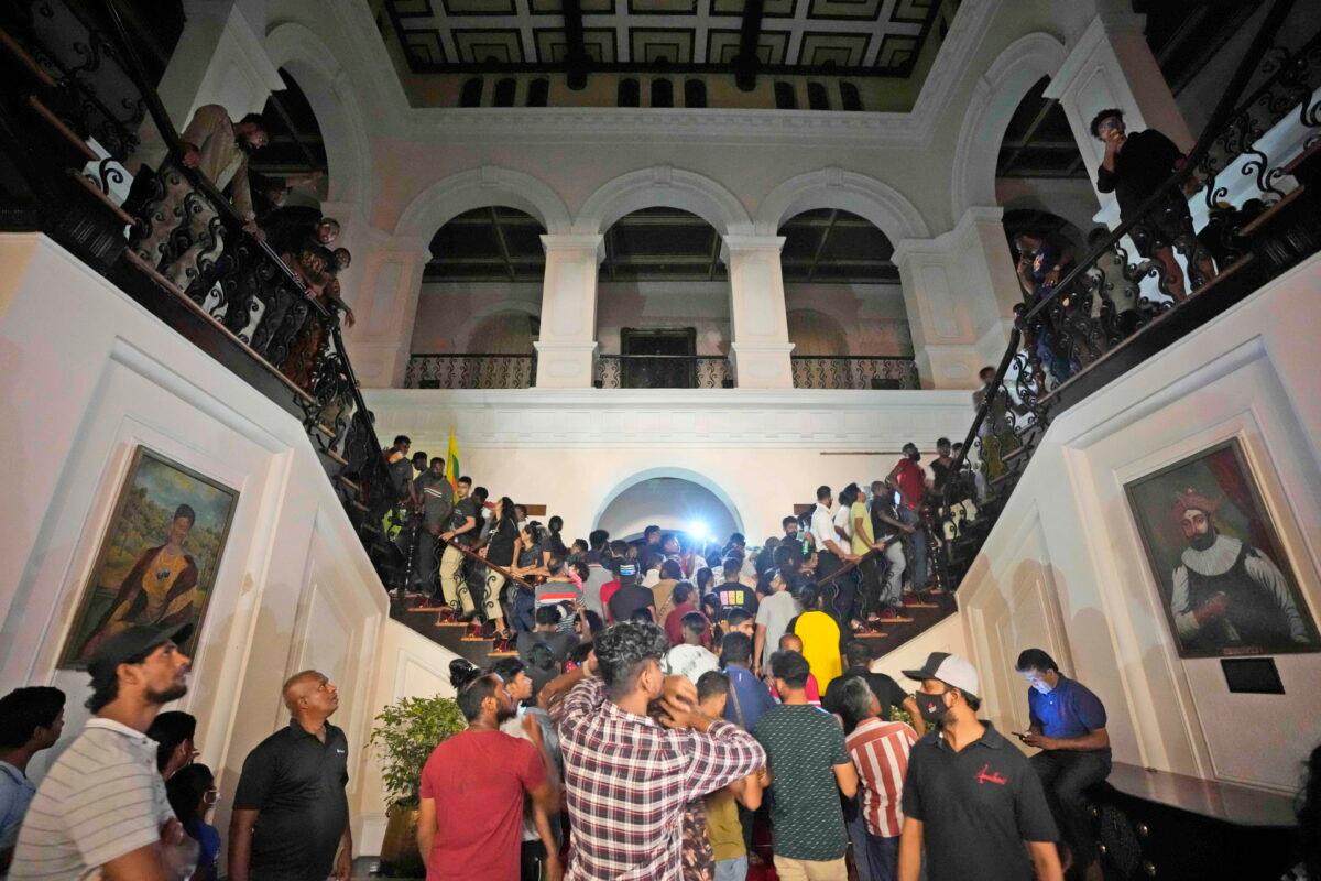 Protesters storm into the Sri Lankan president's official residence in Colombo, Sri Lanka, on July 9, 2022. (Eranga Jayawardena/AP Photo)