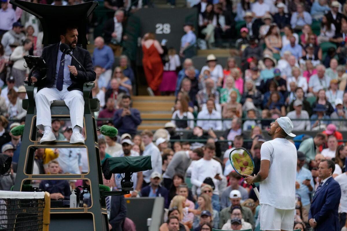 Australia's Nick Kyrgios talks to the umpire during a third round men's singles match against Greece's Stefanos Tsitsipas on day six of the Wimbledon tennis championships in London on July 2, 2022. (Kirsty Wigglesworth/AP Photo)