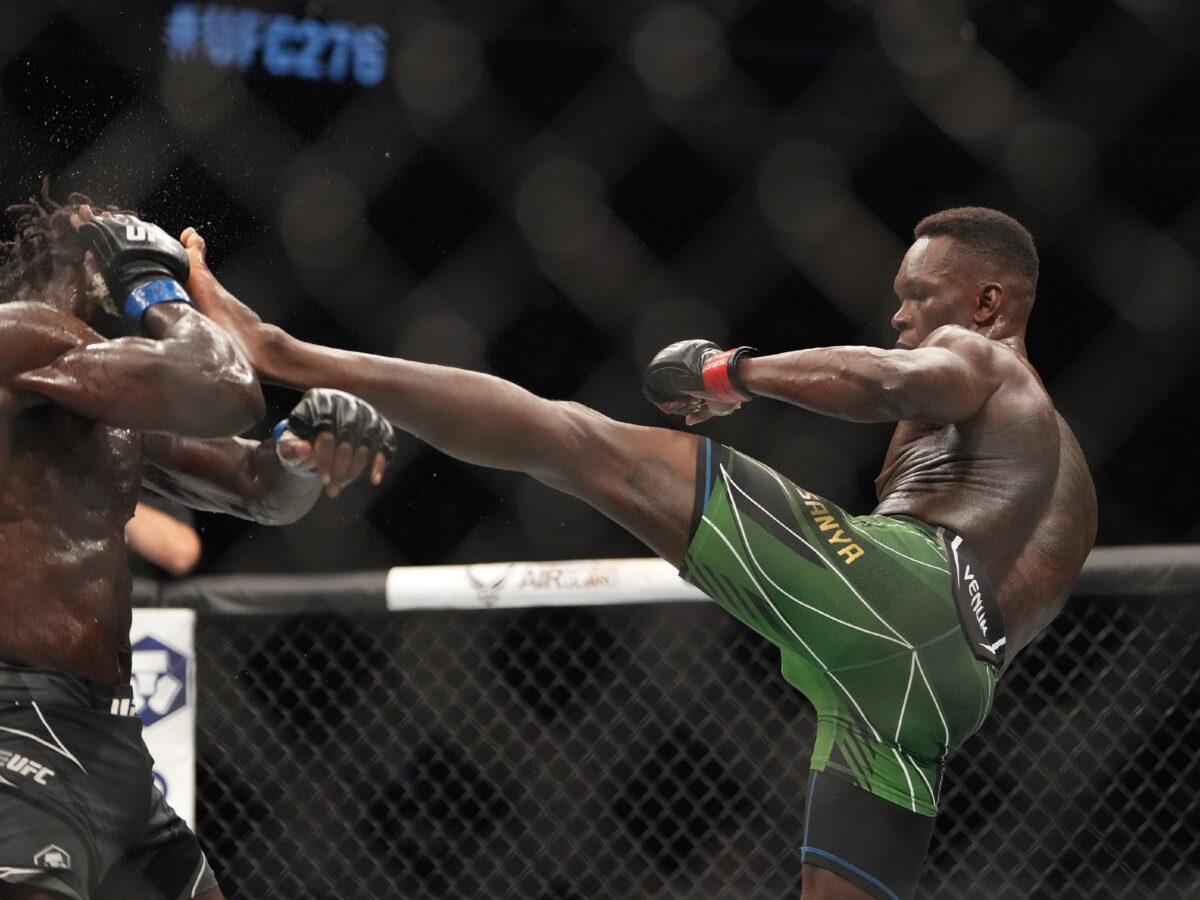 Israel Adesanya (red gloves) and Jared Cannonier (blue gloves) fight in a bout during UFC 276 at T-Mobile Arena in Las Vegas on July 2, 2022. (Stephen R. Sylvanie/USA TODAY Sports via Reuters)