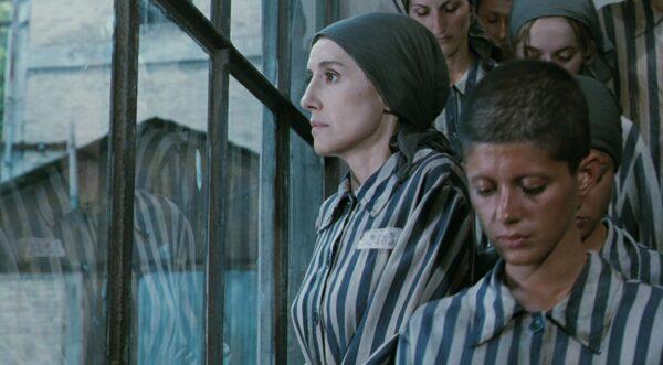 Dora (Nicoletta Braschi, L), although not Jewish, joins her family in the concentration camp, in "Life Is Beautiful." (Melampo Cinematografica)
