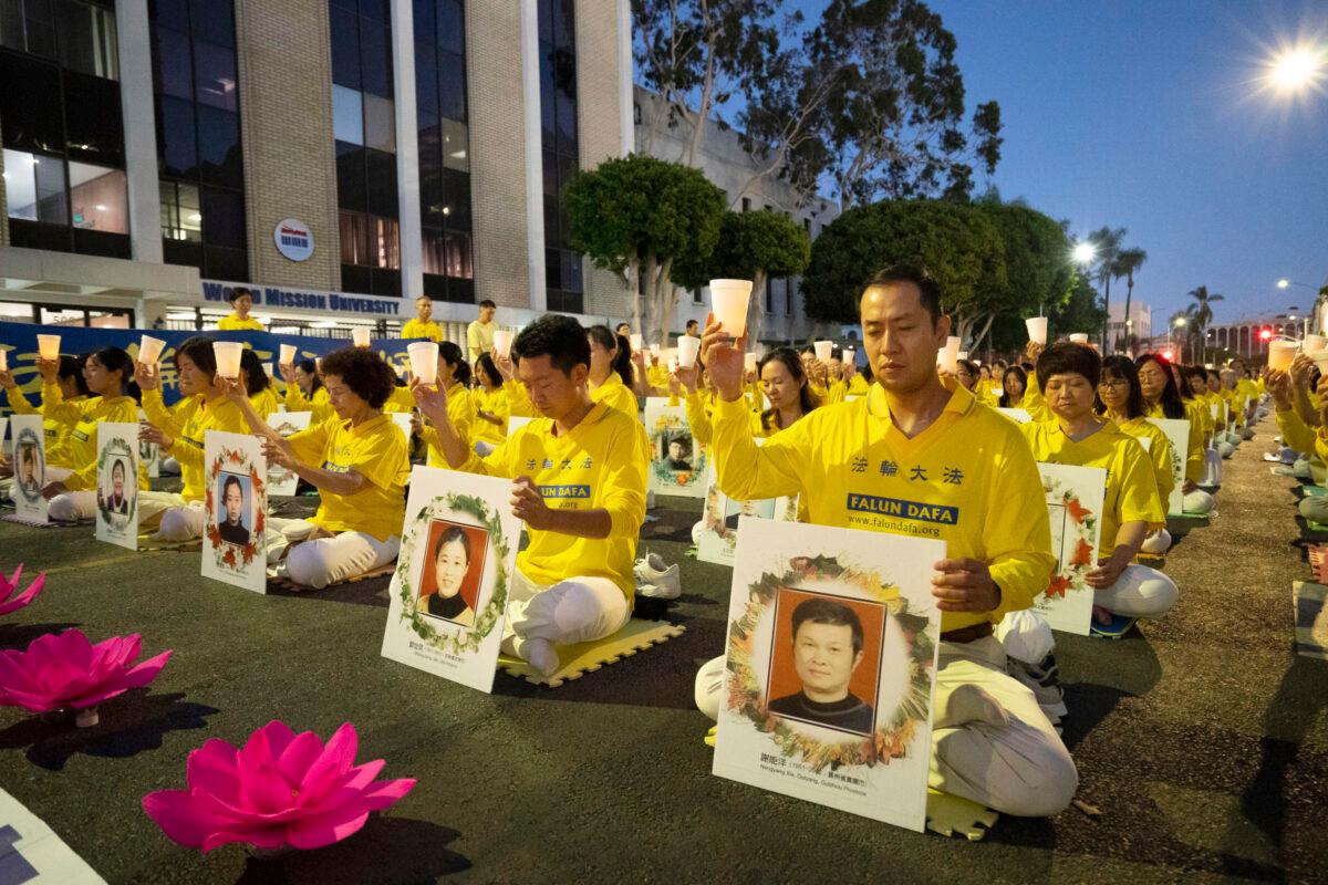 Falun Gong adherents hold a candlelight vigil in front of the Chinese Consulate to mark the 23 years of persecution by the Chinese Communist Party in Los Angeles, Calif., on July 18, 2022. (Debora Cheng/The Epoch Times)
