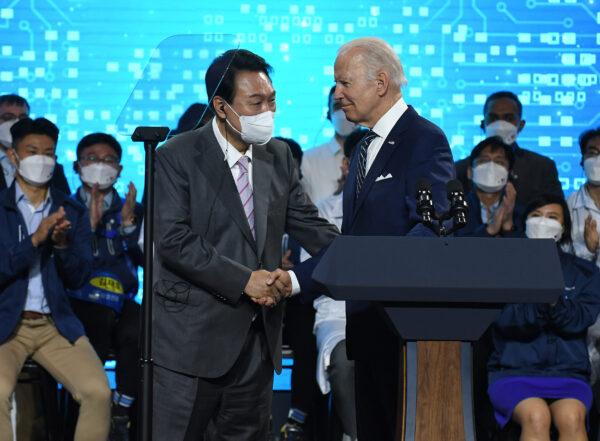 U.S. President Joe Biden shakes hands with South Korean President Yoon Suk-yeol as they visit the Samsung Electronics Pyeongtaek campus in Pyeongtaek, South Korea, on May 20, 2022. President Joe Biden arrived in South Korea on Friday for his first summit with President Yoon Suk-yeol on a range of issues, including North Korea's nuclear program and supply chain risks. (Kim Min-Hee /Pool /Getty Images)