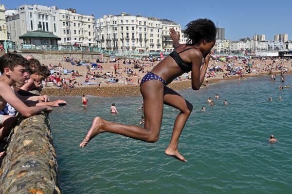Holding your nose while jumping into warm, fresh water can prevent the amoeba from reaching close to your brain. Photo taken in the United Kingdom on Aug. 7, 2020. (Glyn Kirk/AFP via Getty Images)